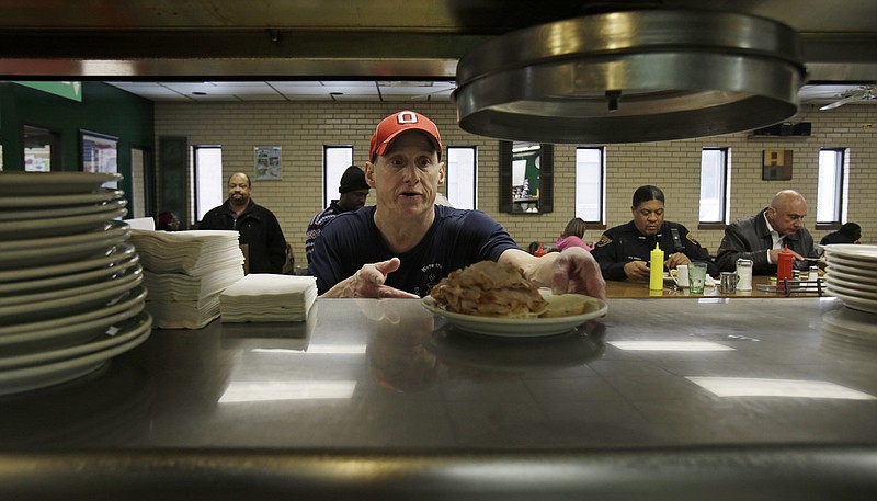 
              In this Jan. 23, 2015 photo, Mark Childers grabs a turkey reuben sandwich to deliver to a customer at the Superior Restaurant Friday, in Cleveland. The Labor Department reports on state unemployment rates for January on Tuesday, March 17, 2015. (AP Photo/Tony Dejak)
            