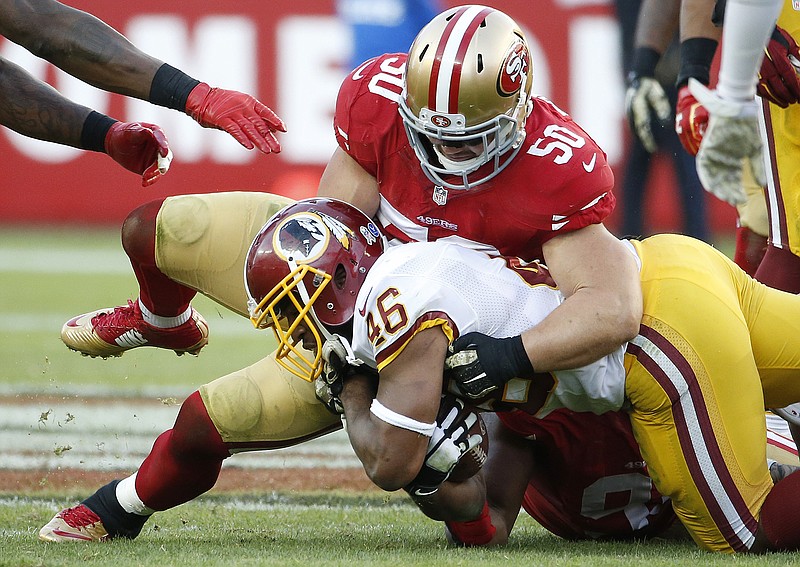 In this Sunday, Nov. 23, 2014, file photo, San Francisco 49ers inside linebacker Chris Borland (50) tackles Washington Redskins running back Alfred Morris (46) during the second half of an NFL football game in Santa Clara, Calif. The 49ers announced late Monday, March 16, 2015, that Borland is retiring after one season, without offering specifics.