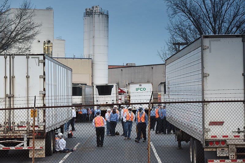 Wrigley workers laugh and make jokes in the parking lot shortly after Chattanooga firefighters extinguished a blaze at the safety-challenged Chattanooga candy plant. 