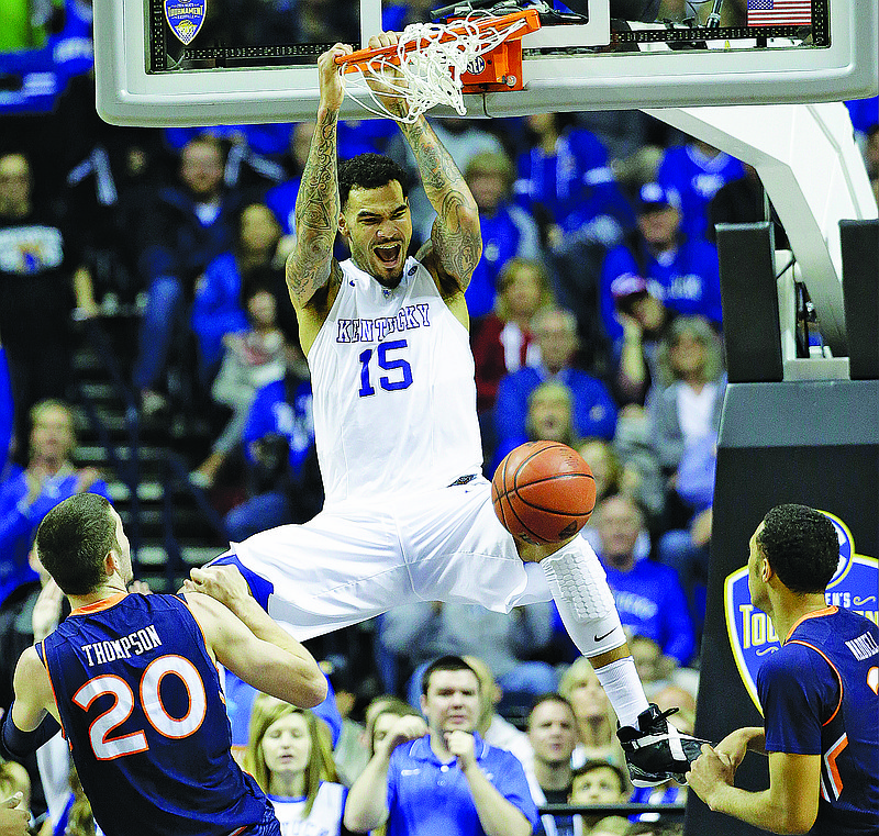 Kentucky forward Willie Cauley-Stein (15) dunks the ball as Auburn forward Alex Thompson (20) and Auburn guard Devin Waddell look on during the second half of an NCAA college basketball game in the semifinal round of the Southeastern Conference tournament,