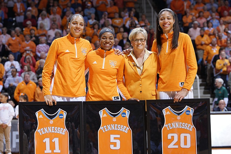 In this March 1, 2015, file photo, Tennessee seniors Cierra Burdick (11), Ariel Massengale (5), and Isabelle Harrison (20) were honored by coach Holly Warlick before the start of their last regular season home game against Vanderbilt at an NCAA college basketball game in Knoxville