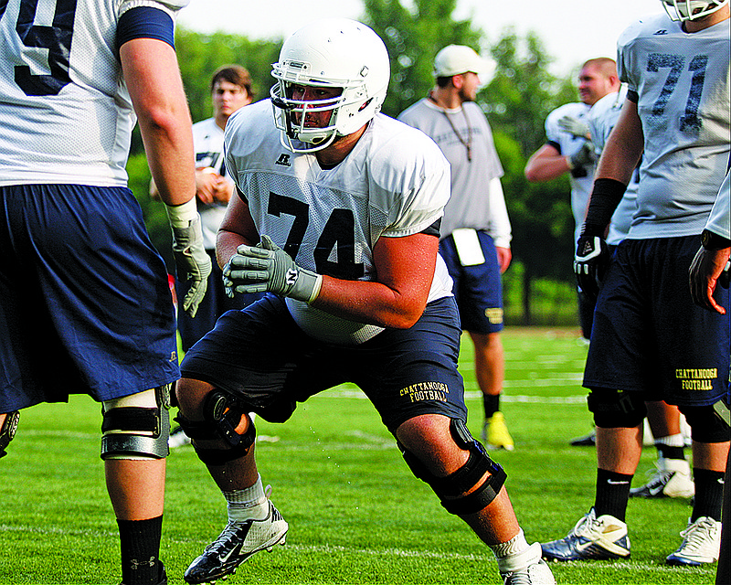 UTC offensive lineman Synjen Herren (74) runs a blocking drill during the Mocs' 3rd practice of the preseason Friday, Aug. 2, 2013, at Scrappy Moore Field in Chattanooga, Tenn.