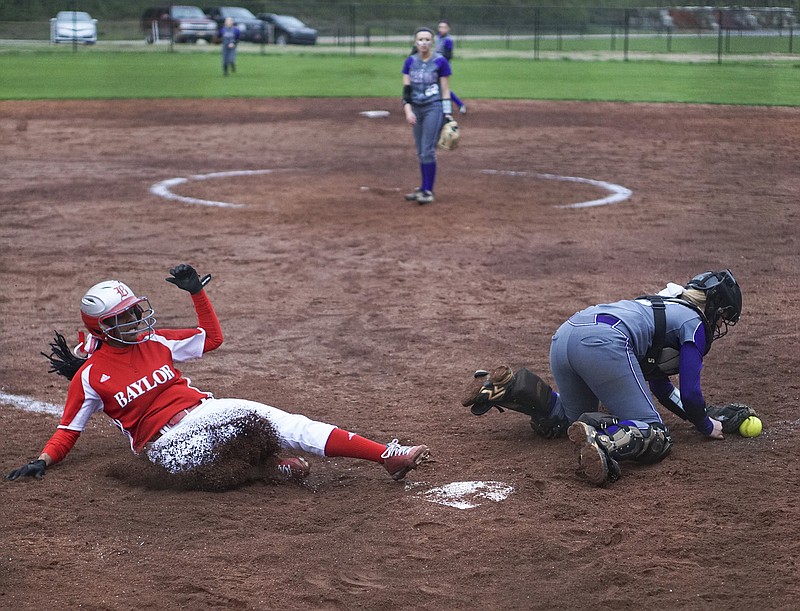 Baylor School's Maya Mathis (15) slides into home scoring as Marion County's Brianna Havner (10) scrambles for the ball during their matchup Friday afternoon at the Red Raider's home field. Baylor School won over Marion County with a final score of 5-2. 