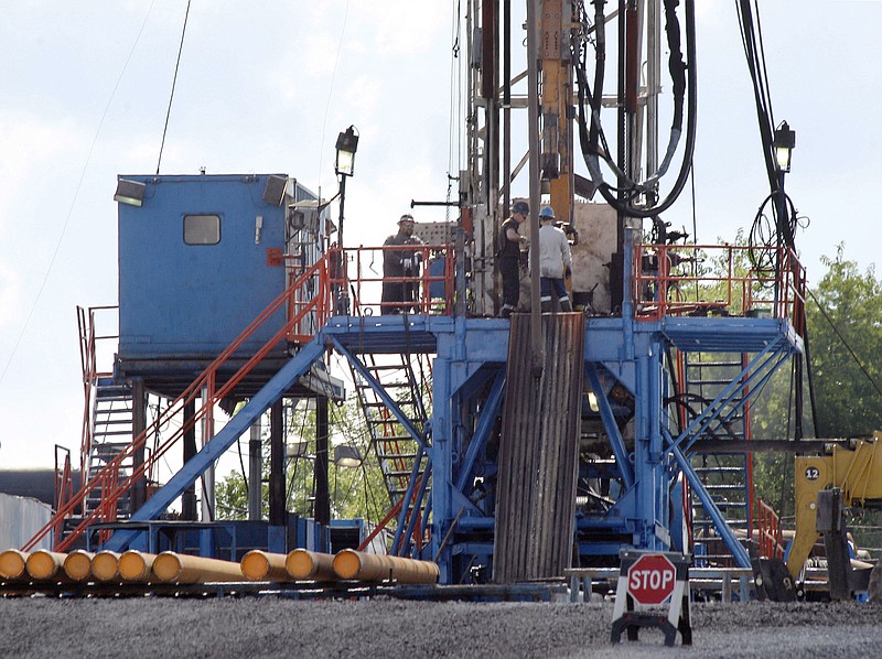 In this June 25, 2012, file photo, a crew works on a gas drilling rig at a well site for shale based natural gas in Zelienople, Pa. The Obama administration is requiring companies that drill for oil and natural gas on federal lands to disclose chemicals used in hydraulic fracturing operations. A final rule released Friday also updates requirements for well construction and disposal of water and other fluids used in fracking, a drilling method that has prompted an ongoing boom in natural gas production. (AP Photo/Keith Srakocic, File)
            