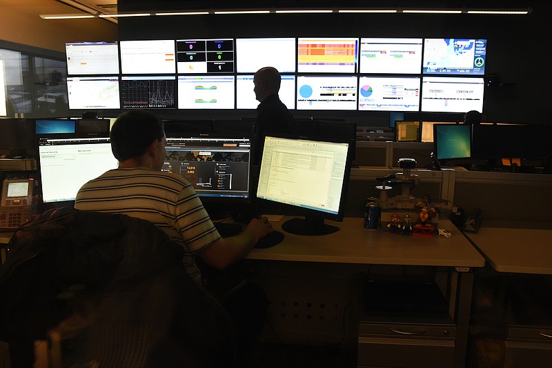 Two men man the EPB Fiber Optic control room.