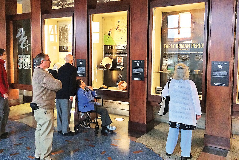 Museum Center at Five Points members take a close look at artifacts associated with "Khirbet el-Maqatir: History of a Biblical Site."