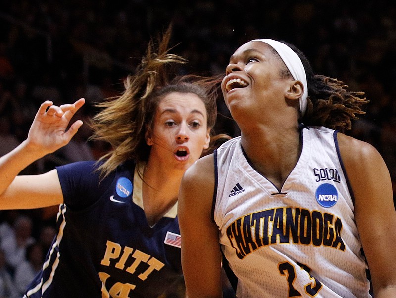 UTC guard Moses Johnson (23) tries to shoot around Pittsburgh guard Fred Potvin (14) in the first half of the Mocs' NCAA tournament basketball game against the Pittsburgh Panthers on Saturday, March 21, 2015, at the Thompson-Boling Arena in Knoxville, Tenn.