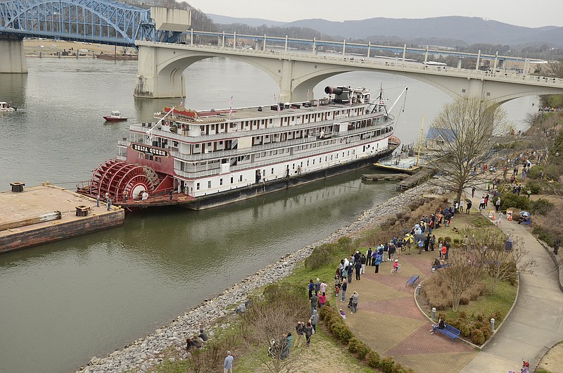 Spectators line the bank of the Tennessee River as the Delta Queen paddle wheel steamboat waits for departure from Coolidge Park on Sunday, Mar. 22, 2015, in Chattanooga.