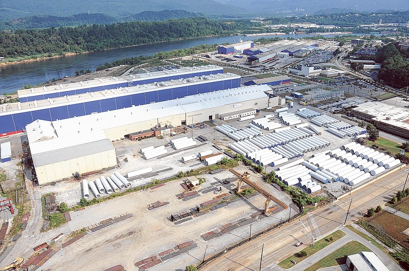 Alstom Power has sold a large tract off Riverfront Parkway that once held wind tower maker Aerisyn. This file photo shows the large white manufacturing bays along with tower segments stored on the parcel. The blue bays are Alstom's turbomachinery plant.