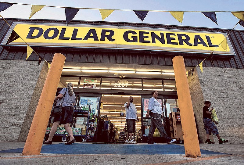 In this AP file photo, customers leave a Dollar General store in San Antonio.