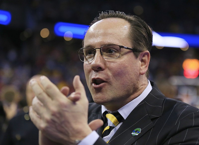 
              Wichita State coach Greg Marshall applauds fans following an NCAA tournament college basketball game against Kansas in the Round of 32 in Omaha, Neb., Sunday, March 22, 2015. Wichita State won 78-65. (AP Photo/Nati Harnik)
            