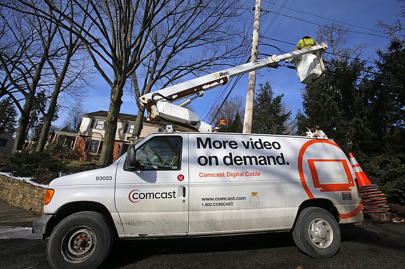 A Comcast cable truck works in Mount Lebanon, Pa, in this 2014 file photo.