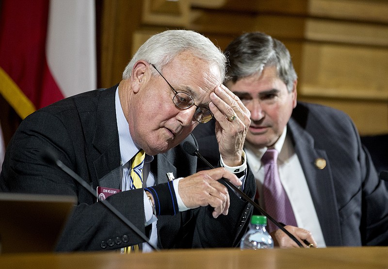 Rep. John Meadows, R-Calhoun, left, and Rep. Richard Smith, R-Columbus, talk during a hearing at Georgia's  State Capitol on Tuesday, March 26, 2013, in Atlanta. 