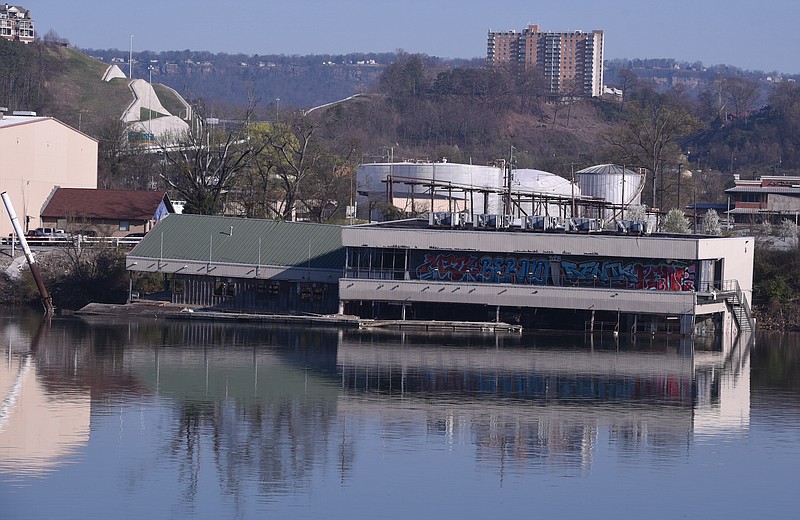 The abandoned restaurant barge known as the Casey barge is seenTuesday, Mar. 24, 2015, in Chattanooga, Tenn., after sinking deeper into the Tennessee River and suffering more structural damage overnight. 