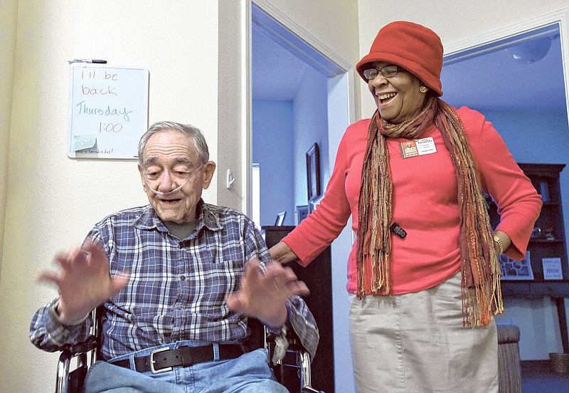 Hospice volunteer Geraldyne North laughs with Pete Miller at Elmcroft Senior Living on Lee Highway.