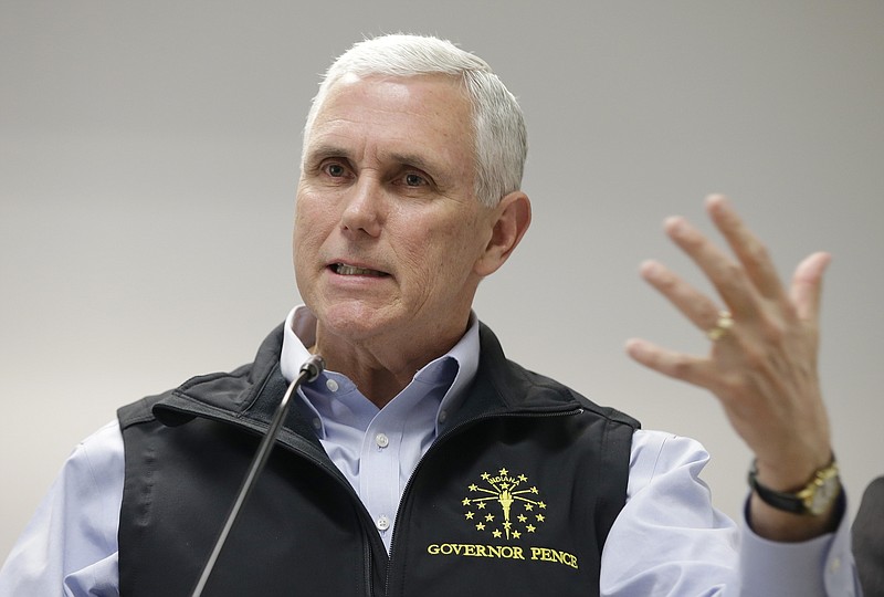 
              Indiana Gov. Mike Pence responds to a question during a news conference Wednesday, March 25, 2015, in Scottsburg, Ind. Pence held a news conference after meeting with local officials in Scott County about an HIV outbreak. (AP Photo/Darron Cummings)
            