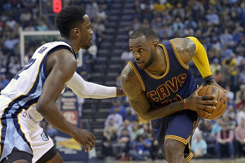 Cleveland Cavaliers forward LeBron James (23) controls the ball against Memphis Grizzlies forward Jeff Green (32) in their game Wednesday, March 25, 2015, in Memphis.