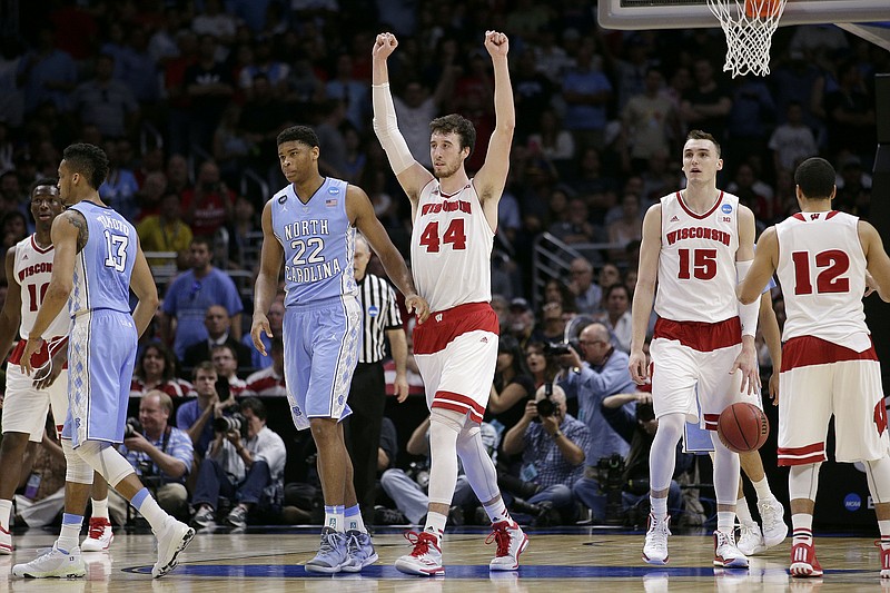 
              Wisconsin forward Frank Kaminsky (44) reacts next to North Carolina forward Isaiah Hicks (22) after Wisconsin beat North Carolina 79-72 in a college basketball regional semifinal in the NCAA Tournament, Thursday, March 26, 2015, in Los Angeles. (AP Photo/Jae C. Hong)
            