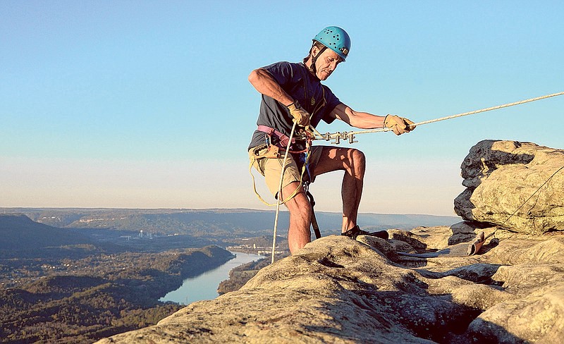 Michael Green prepares to descend the face of a cliff at Sunset Rock on Lookout Mountain near Chattanooga.