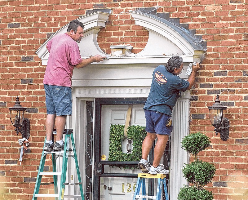 William Lynn, left, and Gary Dabbs of McKaig Construction prep a doorway for painting in the City of Ridgeside. 