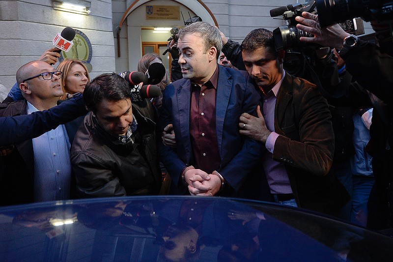 
              In this picture taken on Wednesday, March 25, 2015, former Romanian finance minister Darius Valcov exits handcuffed from the prosecutors office in Bucharest, Romania.   Romanian prosecutors investigating an alleged bribery scheme have questioned the former finance minister about the origins of 100 paintings, including three works by Pablo Picasso.  Prosecutors questioned Darius Valcov on Friday March 27, 2015, saying the paintings had been hidden by four of his friends. The works have been sent to art experts for evaluation. Valcov, under house arrest since Thursday, declined to comment.  (AP Photo/Octav Ganea, Mediafax) ROMANIA OUT
            