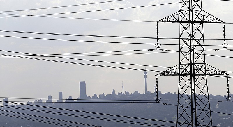 
              File: In this photo taken Tuesday, March 10, 2015 electricity pylons cross the skyline of Johannesburg city, background. About 1,000 workers have been fired following an illegal strike that has halted construction at an already delayed but much needed power plant in South Africa, a spokesman for the state-owned power utility said on Friday. (AP Photo/Themba Hadebe-File)
            