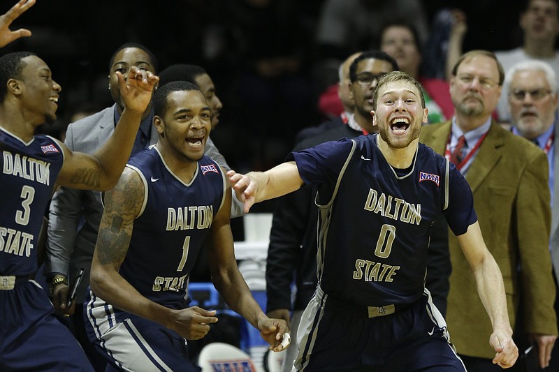 Dalton State forward Jordan Bowling, right, celebrates with teammate Anthony Hillard (3) and Jarmaine Burrey (1) following the NAIA championship basketball game against Westmont College in Kansas City, Mo., on March 24, 2015. Bowling scored 18 points in the game. Dalton State defeated Westmont 71-53. 