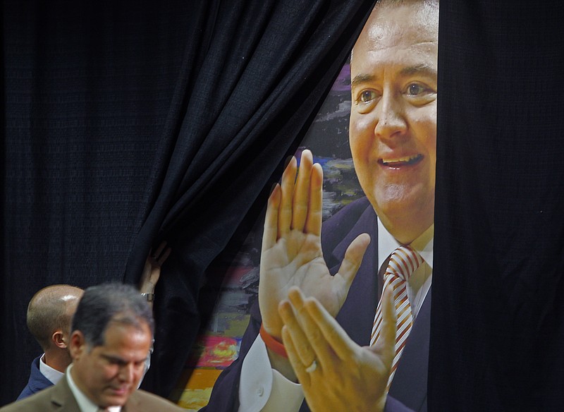 The curtain over a wall mural of University of Tennessee head basketball coach Donnie Tyndall, is pulled back Friday, March 27, 2015, in Knoxville. Tennessee fired men's basketball coach Donnie Tyndall after one season, though athletic director Dave Hart says the university never would have hired him if they knew the details of his unethical conduct at Southern Miss program during his tenure there.
