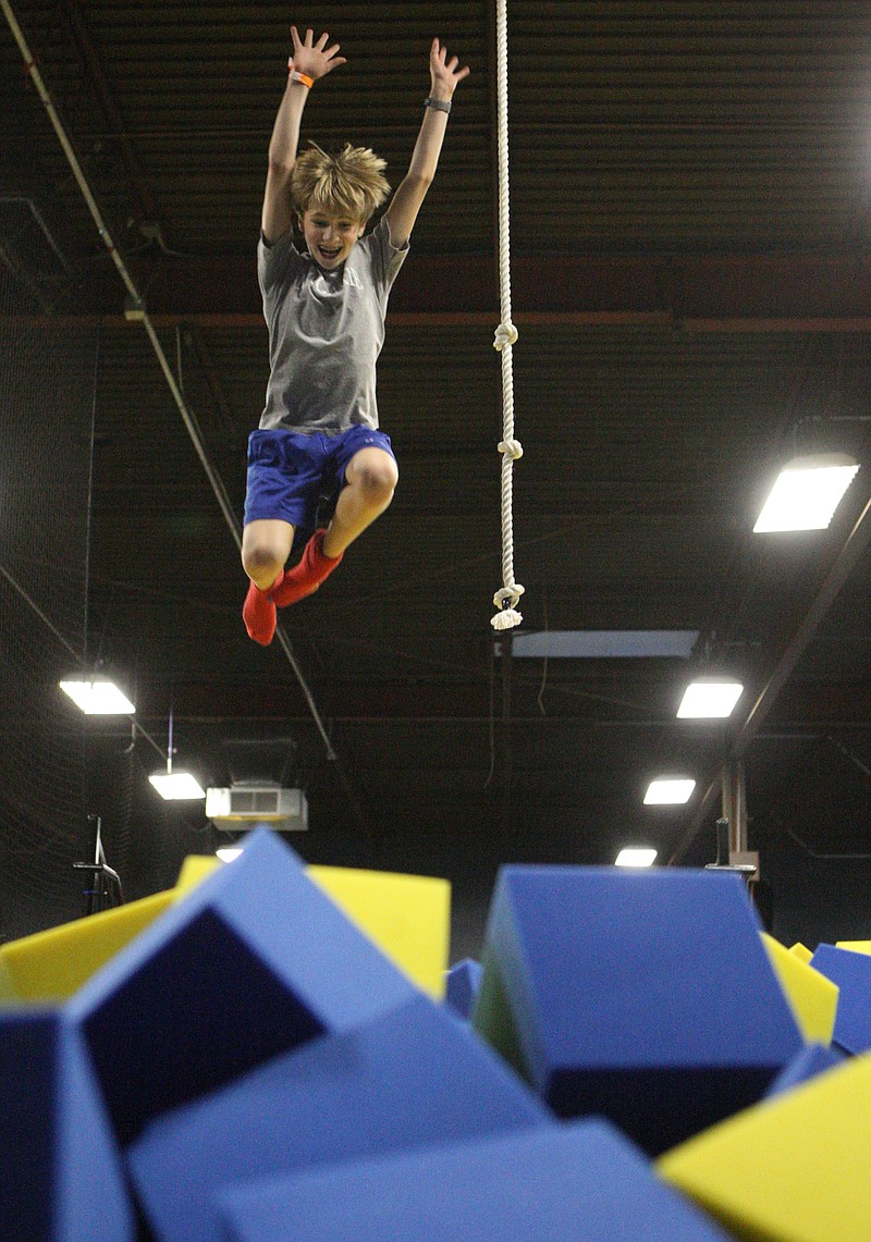 Conner Jones, 13, launches himself into a foam pit at the Jump Park