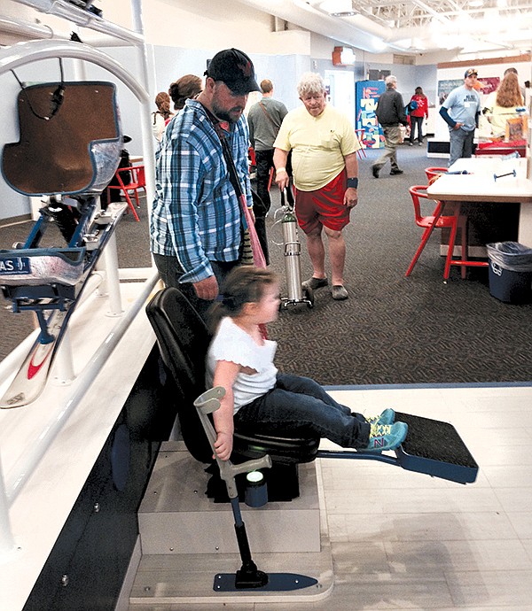 Corrine Howard, 4, checks out a mono- ski simulator as part of the "Human Plus Day" exhibit at the Creative Discovery Museum on Saturday.