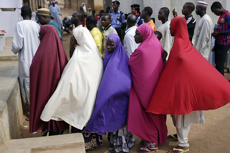 
              Nigerians wait for to register before voting in Jere, some 60 kilometers (40 miles) from the capital Abuja, Nigeria Saturday, March 28, 2015. Nigerians are going to the polls on Saturday to vote in presidential elections. (AP Photo/Jerome Delay)
            