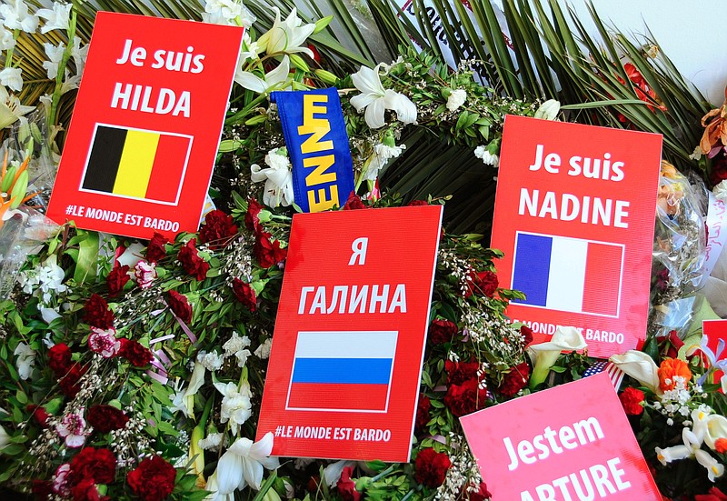 
              Placards reading "I am Hilda", and "I am Nadine", names of the victims of the attack on the Bardo Museum, are laid at the entrance of the Bardo museum, in Tunis, Tunisia, Sunday, March 29, 2015. Tens of thousands of Tunisians attended a march in their country's capital, Tunis, on Sunday to denounce extremist violence following the attack on the National Bardo Museum. (AP Photo/Hassene Dridi)
            