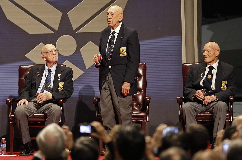 
              FILE - In this Nov. 9, 2013 Richard Cole, center, proposes a toast with two other surviving members of the 1942 Tokyo raid led by Lt. Col. Jimmy Doolittle, Edward Saylor, left, and David Thatcher, at the National Museum for the US Air Force in Dayton, Ohio. The group will receive the Congressional Gold Medal on April 15, 2015, in Washington, then hand it over April 18 to the museum for display  its exhibit depicting the launch from an aircraft carrier of the Raiders’ daring 1942 bombing attack on mainland Japan. (AP Photo/Al Behrman, File)
            