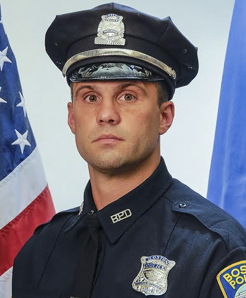 
              This undated photo released by the Boston Police Department's official Twitter account Saturday, March 28, 2015, shows Officer John Moynihan, 34, who was shot in the face during a traffic stop Friday night that ended when other officers fatally shot his attacker. Moynihan was struck just below his right eye and was listed in critical condition Saturday as the bullet remained lodged below his right ear. A decorated veteran, Moynihan served in Iraq in 2006-2007 and was honored at the White House in May 2014 for being one of the first responders in Watertown, Mass., following the April 2013 gun battle with the Boston Marathon bombers. (AP Photo/Boston Police Department)
            