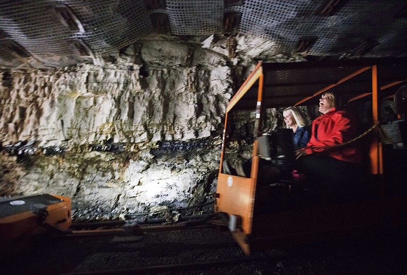 
              ADVANCE FOR USE MONDAY, MARCH 30, 2014 AND THEREAFTER - In this Oct. 18, 2014 photo, tourists ride a rail car in the Portal 31 coal mine that has been turned into a tourist attraction in Lynch, Ky. As coal and other signature industries wane, officials across the region are looking for something to replace those jobs and revenues. (AP Photo/David Goldman)
            