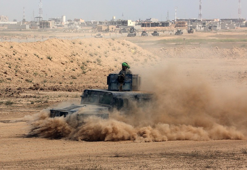 
              Iraqi security forces prepare to attack Islamic State extremist positions during clashes in Tikrit, 130 kilometers (80 miles) north of Baghdad, Iraq, Saturday, March 28, 2015. The Iraqi troops pressed their push in the city Saturday against IS militants holed up in the center of the city. (AP Photo/Khalid Mohammed)
            