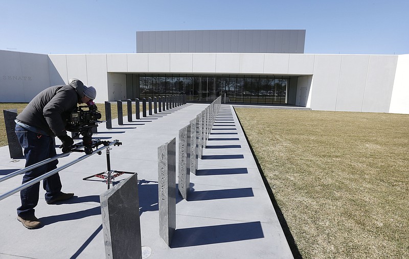 
              In this Monday, March 23, 2015 photo, a television cameraman films near the entrance to the Edward M. Kennedy Institute, in Boston.  The $79 million institute is scheduled to be dedicated on Monday, March 30, 2015. (AP Photo/Steven Senne)
            