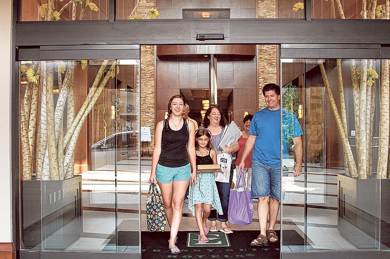 The Roberts and Jones families check out of the Hamilton Place Embassy Suites hotel while on vacation recently. The hotel has been ranked highly by both Trip Advisor and Expedia.