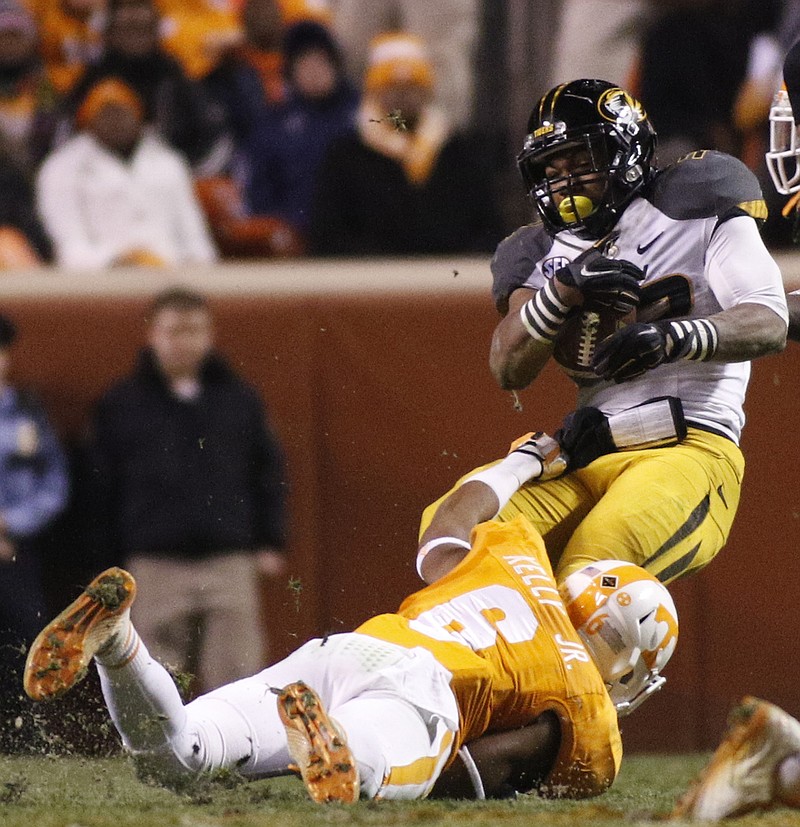 Tennessee defensive back Todd Kelly, Jr., tackles Missouri's Russell Hansbrough during the Vols' football game against the Missouri Tigers on Saturday, Nov. 22, 2014, at Neyland Stadium in Knoxville.