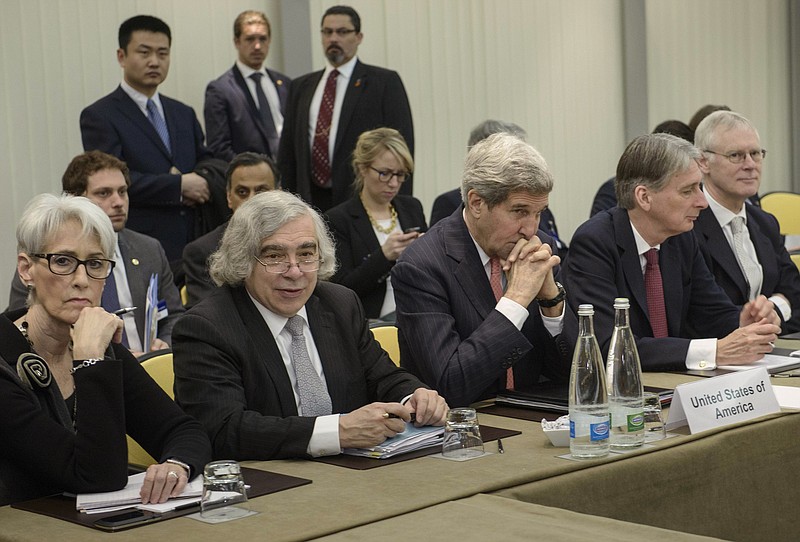 
              U.S. Secretary of State John Kerry, center, and British Foreign Secretary Philip Hammond, second right, waits with U.S. Under Secretary for Political Affairs Wendy Sherman, left, U.S. Secretary of Energy Ernest Moniz, second left, and others before a meeting with Russia, China, France, Germany, European Union and Iranian officials at the Beau Rivage Palace Hotel in Lausanne, Switzerland Monday, March 30, 2015, during Iran nuclear talks. Negotiations over Iran's nuclear program are entering a critical phase with differences still remaining just two days before a deadline for the outline of an agreement. (AP Photo/Brendan Smialowski, Pool)
            