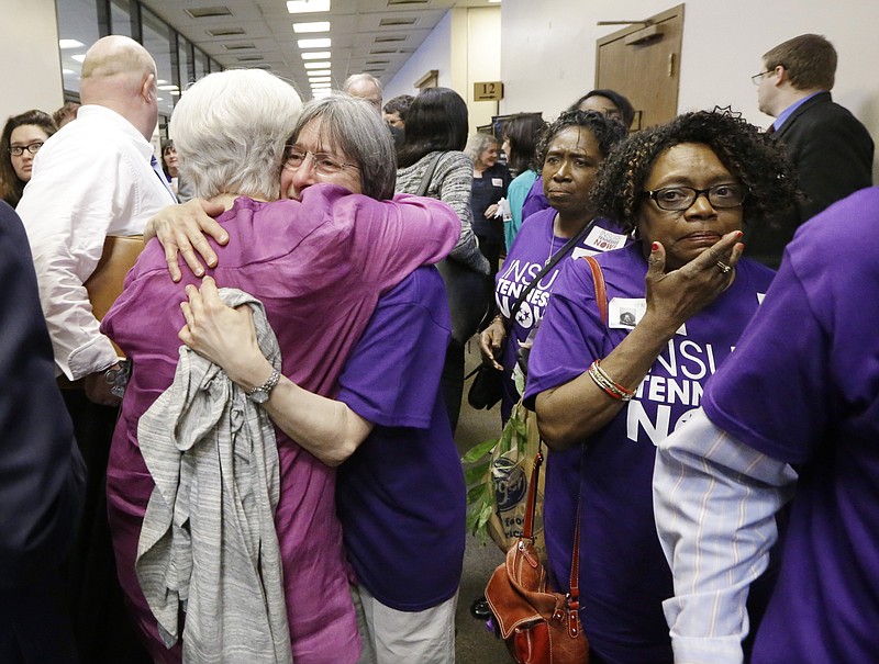 
              Supporters of Gov. Bill Haslam's Insure Tennessee proposal console one another after attending a meeting of the Senate Commerce Committee to hear debate on the measure Tuesday, March 31, 2015, in Nashville, Tenn. The proposal to extend health coverage to about 280,000 low-income Tennesseans was defeated 6-2. (AP Photo/Mark Humphrey)
            