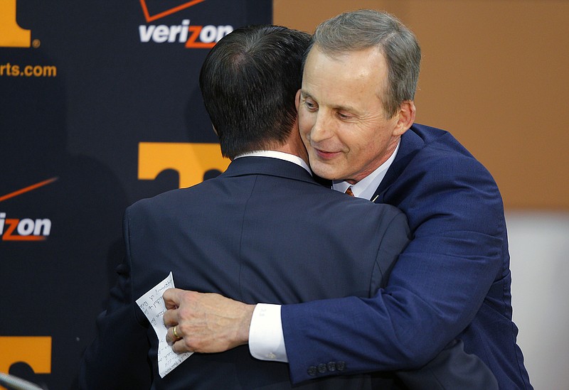 Former University of Texas head basketball coach Rick Barnes hugs athletic director Dave Hart after being introduced as the new head coach at the University of Tennessee on Tuesday, March 31, 2015, in Knoxville.