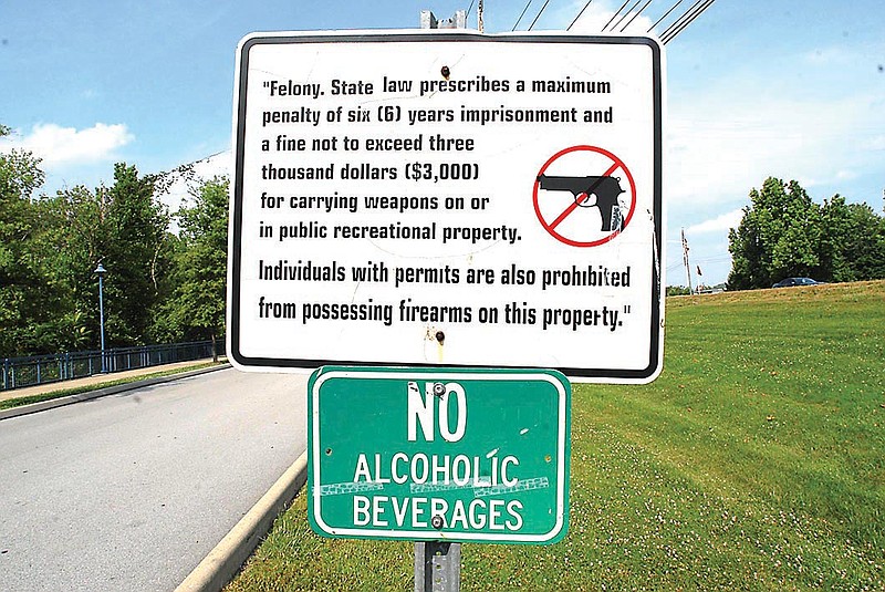 A sign prohibiting firearms is seen at the Tennessee Riverpark. The Hamilton County commission voted to ban firearms in Hamilton County parks on Wednesday.