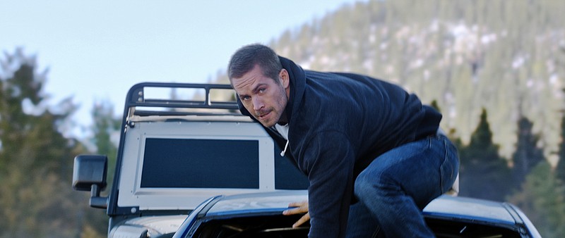 
              This photo provided by Universal Pictures shows Paul Walker as Brian in a scene from "Furious 7."  When the high-speed action sequel “Furious 7” debuts this weekend, audiences at Hollywood’s famous TCL Chinese Theatre will see every tire skid and fist fight in Imax’s brand-new laser format. (AP Photo/Universal Pictures)
            