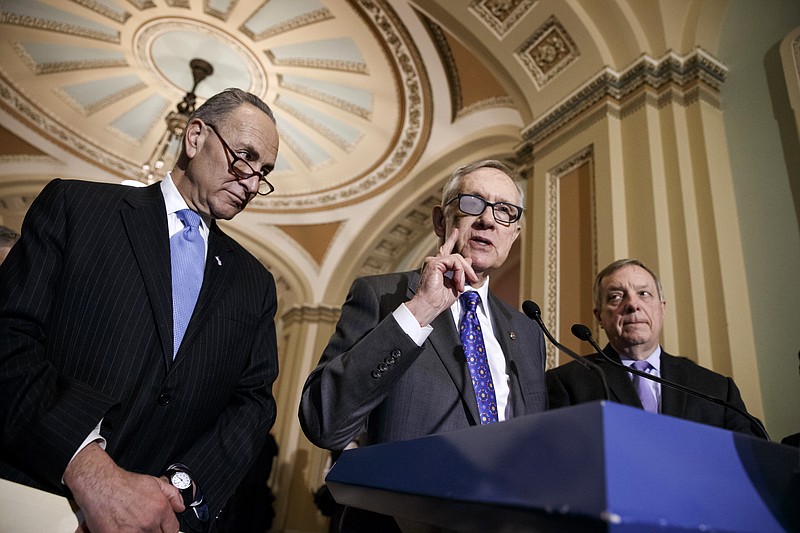
              FILE - In this March 3, 2015 file photo, Senate Minority Leader Harry Reid of Nev., center, flanked by Sen. Charles Schumer, D-N.Y., left, and Senate Minority Whip Richard Durbin of Ill., speaks during a news conference on Capitol Hill in Washington. In the wake of the announced retirement of  Reid, a very public feud has opened between the No. 2 and No. 3 Senate Democrats and former long-time housemates, Schumer and Durbin.  (AP Photo/J. Scott Applewhite, File)
            