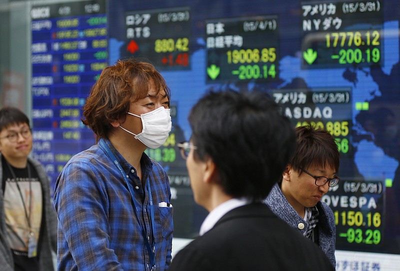 
              People walk by an electronic stock indicator of a securities firm in Tokyo, Wednesday, April 1, 2015. Asian stock markets were lackluster Wednesday as China's manufacturing remained weak in February and a Japanese central bank survey showed businesses are wary about the economic outlook. (AP Photo/Shizuo Kambayashi)
            