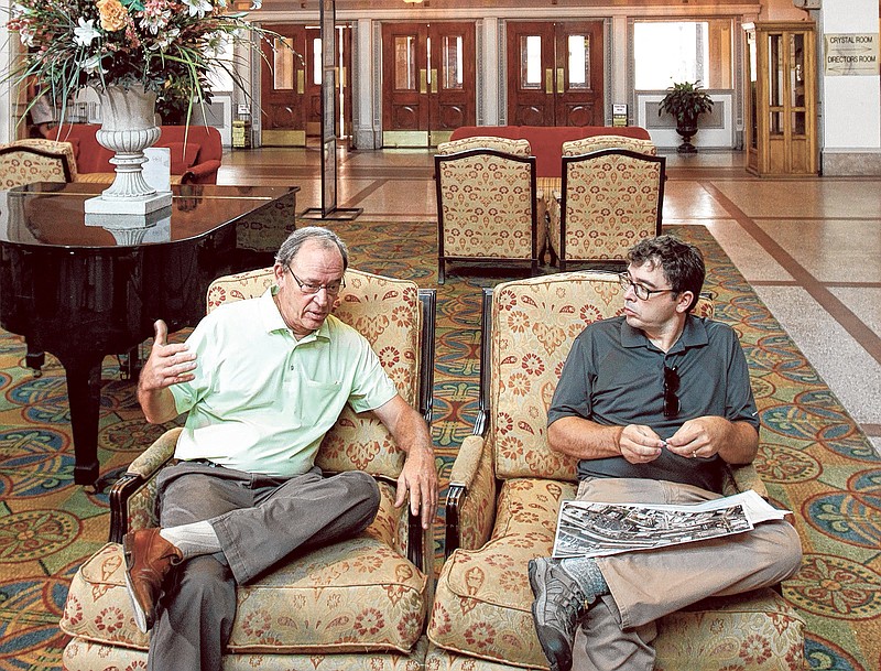 Jon Kinsey, left, and his son, Adam, talk about plans beneath the grand dome in the Chattanooga Choo Choo.