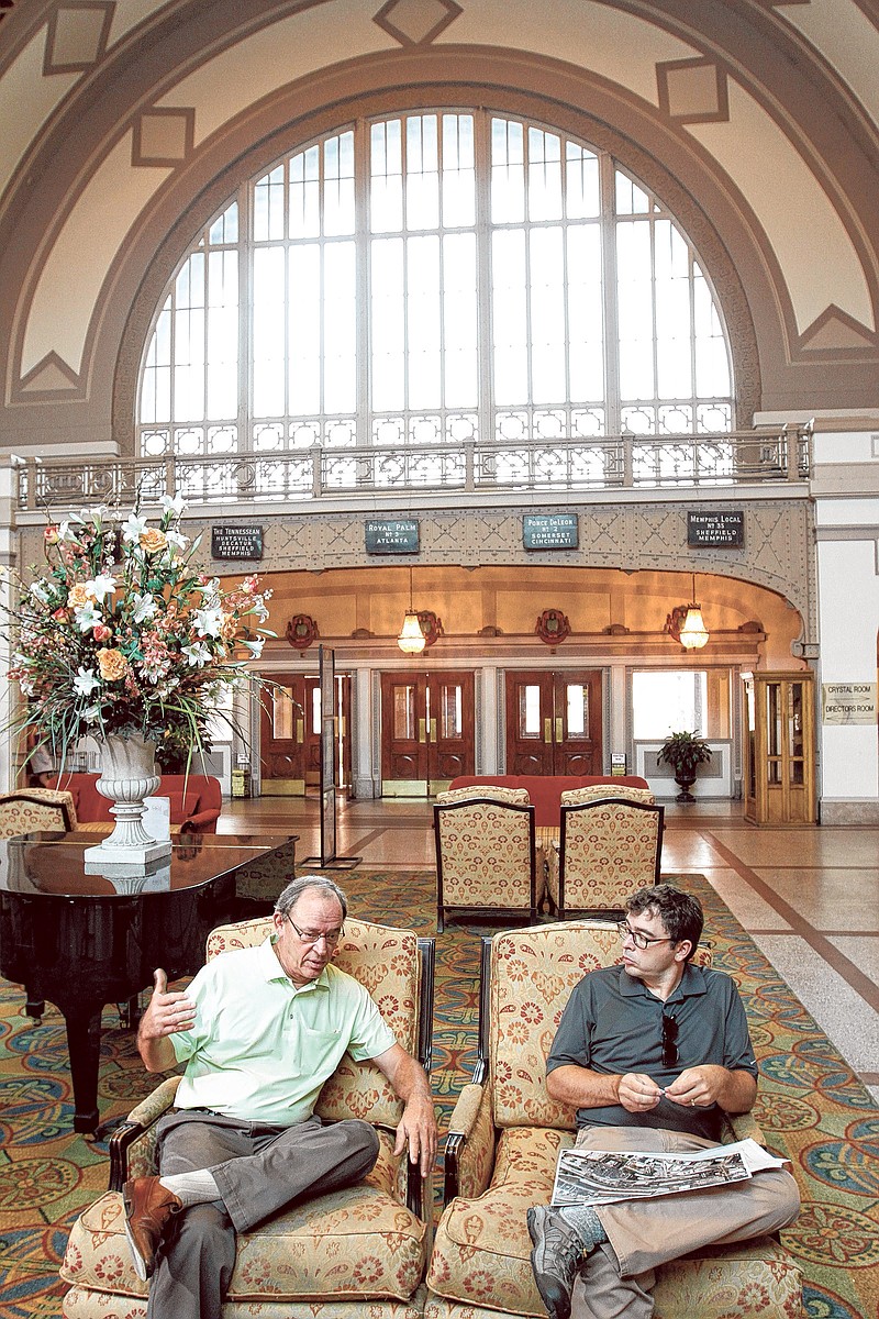 Jon Kinsey, left, and his son, Adam, talk about plans beneath the grand dome in the Chattanooga Choo Choo.