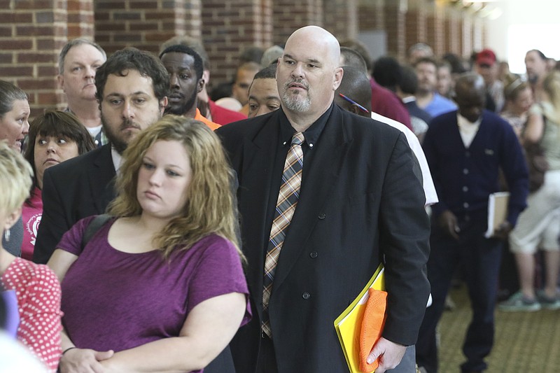 David Dunn from Chickamauga, Ga., right, stands in line with hundreds of other job seekers at The Colonnade in Ringgold, Ga., while attending a huge 15-county job fair on Thursday.