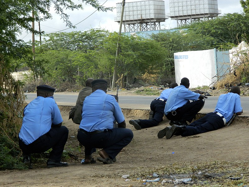 
              Kenyan police officers take cover outside the Garissa University College during an attack by gunmen in Garissa, Kenya, Thursday, April 2, 2015. Gunmen attacked the university early Thursday, shooting indiscriminately in campus hostels. Police and military surrounded the buildings and were trying to secure the area in eastern Kenya, police officer Musa Yego said. (AP Photo)
            